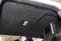 The ceiling of the SUV car pulled by black soft material alkantara in the workshop for tuning and styling the interiorof the