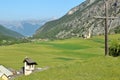 Ceillac village surrounded by green fields, with Saint Sebastien Church on the left, and on the right Sainte Cecile Church