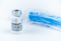 Celadna, Czechia - 05.30.2021: Ampoule of Comirnaty vaccine by Pfizer on white background, with blue syringe in plastic packaging