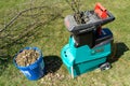 Celadna, Czechia - 04.23.2022: Detail shot of the Bosch electric garden shredder with weathered lawn and pile of cut