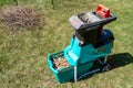 Celadna, Czechia - 04.23.2022: Detail shot of the Bosch electric garden shredder with weathered lawn and pile of cut