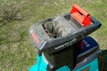 Celadna,. Czechia - 04.23.2022: Detail shot of the plastic top of Bosch electric garden shredder with weathered lawn in