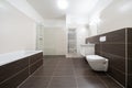 Celadna, Czechia - 05.07.2022: Empty bathroom in modern contemporary style with brown tiles and white walls and ceiling