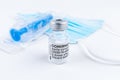 Celadna, Czechia - 05.30.2021: Still life with ampoule of Comirnaty vaccine by Pfizer, blue face mask and blue syringe on white Royalty Free Stock Photo