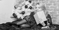 Celebrate christmas without social obligations. Woman hold glass champagne and book. Girl relax near christmas tree