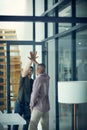 Celebrate every score. two young businessmen giving each other a high five in a modern office. Royalty Free Stock Photo