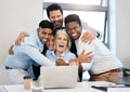 Celebrate every tiny victory. a group of businesspeople cheering in a huddle while using a laptop together in an office.