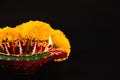 Celebrate Indian Festival Diwali, A beautifully crafted Diwali lamp and intricate flower rangoli