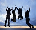 Celebrate life. Always. A group of young adults jumping in excitement against a twilight sky. Royalty Free Stock Photo