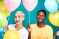 Celebrate the people who add colour to your life. Studio shot of two young women holding a bunch of colourful balloons