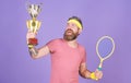 Celebrate victory. Athletic man hold tennis racket and golden goblet. Tennis player win championship. Man bearded Royalty Free Stock Photo