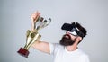 Celebrate victory. Man bearded hipster vr headset holds golden goblet. Feel victory in virtual reality games. Achieve Royalty Free Stock Photo