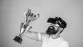 Celebrate victory. Man bearded hipster vr headset holds golden goblet. Feel victory in virtual reality games. Achieve Royalty Free Stock Photo