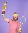 Celebrate victory. Tennis champion. Athletic man hold tennis racket and golden goblet. Win tennis game. Tennis player Royalty Free Stock Photo