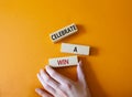 Celebrate a win symbol. Concept words Celebrate a win on wooden blocks. Businessman hand. Beautiful orange background. Business Royalty Free Stock Photo