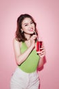 Celebrating asian woman drinking red softdrink