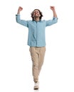 celebrating casual man with hands in the air looking up Royalty Free Stock Photo