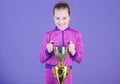 Celebrating childrens achievements great and small. Sport achievement. Celebrate victory. Girl hold golden goblet