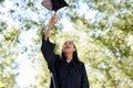 Celebrating graduation, woman and throw hat outdoors with success, achievement and goals in university. Student, excited Royalty Free Stock Photo