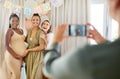 Celebrating with my closest friends. a group of women taking photos at their friends baby shower. Royalty Free Stock Photo