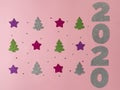 Celebrating the new year 2020. Silver mother-of-pearl paper, number 2020, pink and lilac stars, green and silver