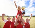 Celebrating our victory. a childrens soccer team holding a trophy. Royalty Free Stock Photo