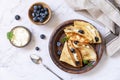 Celebrating Pancake day, healthy breakfast. Delicious homemade crepes with blueberries and ricota on a stone tabletop. Top view Royalty Free Stock Photo