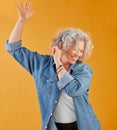 Celebrating, partying and dancing mature woman, happy and cheerful senior making waving hand gesture and smiling