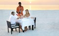 Celebrating a special moment. a mature couple enjoying a romantic dinner on the beach. Royalty Free Stock Photo