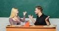 Celebrating success. Happy couple studying in classroom. Man and woman back to school. Pretty teacher and handsome Royalty Free Stock Photo