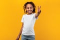 Portrait of smiling black girl showing peace sign Royalty Free Stock Photo