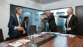 Celebrating success. Two happy business colleagues in formal wear hugging and laughing while having a meeting in the Royalty Free Stock Photo