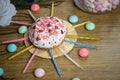 Celebrating sweet cupcake, candles on wooden table, candies birthday party