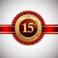 Celebrating 15th anniversary logo, with golden badge and red ribbon isolated on white background