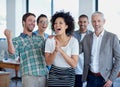 Celebrating their business success. a group of happy coworkers celebrating standing in an office. Royalty Free Stock Photo