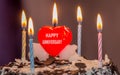 Celebrating wedding anniversary with a beautiful heart shape candle on cake Royalty Free Stock Photo