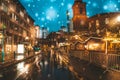 Christmas market spirit during snow night. Royalty Free Stock Photo