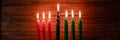 Celebration of African American Kwanzaa festival. Seven burning candles in Kinara candlestick. Royalty Free Stock Photo