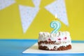 Cake for the second birthday. Cake on a festive background with birthday flags Royalty Free Stock Photo