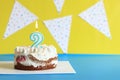 Celebration cake with a lit birthday candle. Cake for the second birthday Royalty Free Stock Photo