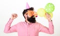 Celebration concept. Guy in party hat with air balloons celebrates. Hipster in giant sunglasses celebrating birthday Royalty Free Stock Photo