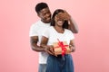 Happy black man making surprise for his woman giving box Royalty Free Stock Photo