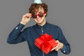 Celebration Concept. Teenager boy in birthday cap taking off sunglasses looking camera smiling playful standing isolated Royalty Free Stock Photo