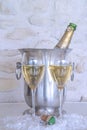 Celebration concept: two glasses of champagne and vintage bottle in the bucket Royalty Free Stock Photo
