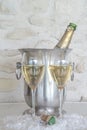 Celebration concept: vintage bottle of champagne in the bucket, two champagne glasses and cork Royalty Free Stock Photo