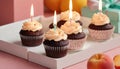 Celebration Cupcakes: Colorful cupcakes with lit candles displayed against a backdrop of wrapped gifts. Captured indoors