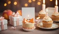 Celebration Cupcakes: Colorful cupcakes with lit candles displayed against a backdrop of wrapped gifts. Captured indoors Royalty Free Stock Photo