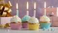 Celebration Cupcakes: Colorful cupcakes with lit candles displayed against a backdrop of wrapped gifts. Captured indoors