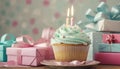 Celebration Cupcakes: Colorful cupcakes with lit candles displayed against a backdrop of wrapped gifts. Captured indoors Royalty Free Stock Photo