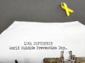 Celebration Day Concept - 10th September world suicide prevention day text typed on white paper background. Stock photo.